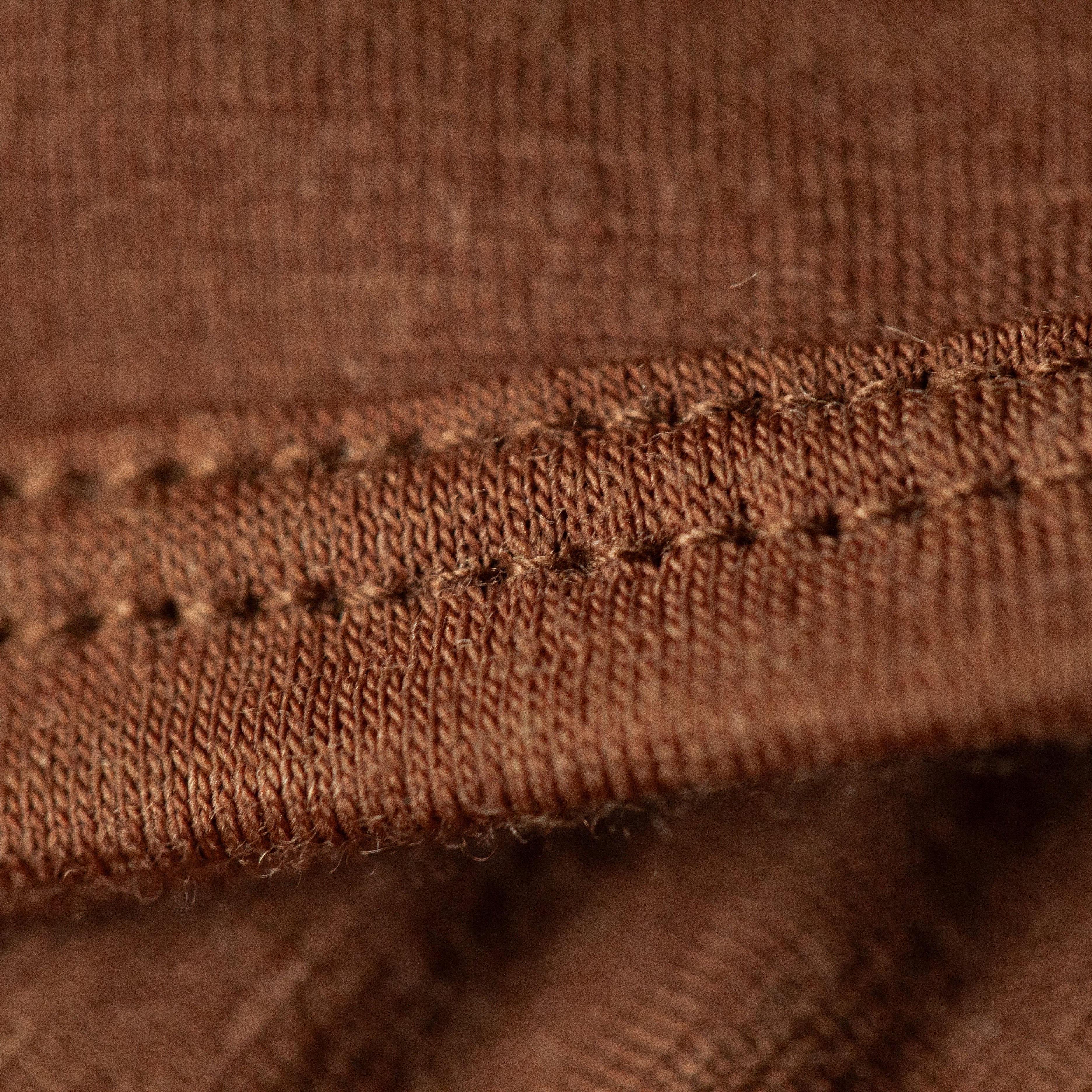 Close-up of the finished edge stitching on the Bark Merino wool blanket