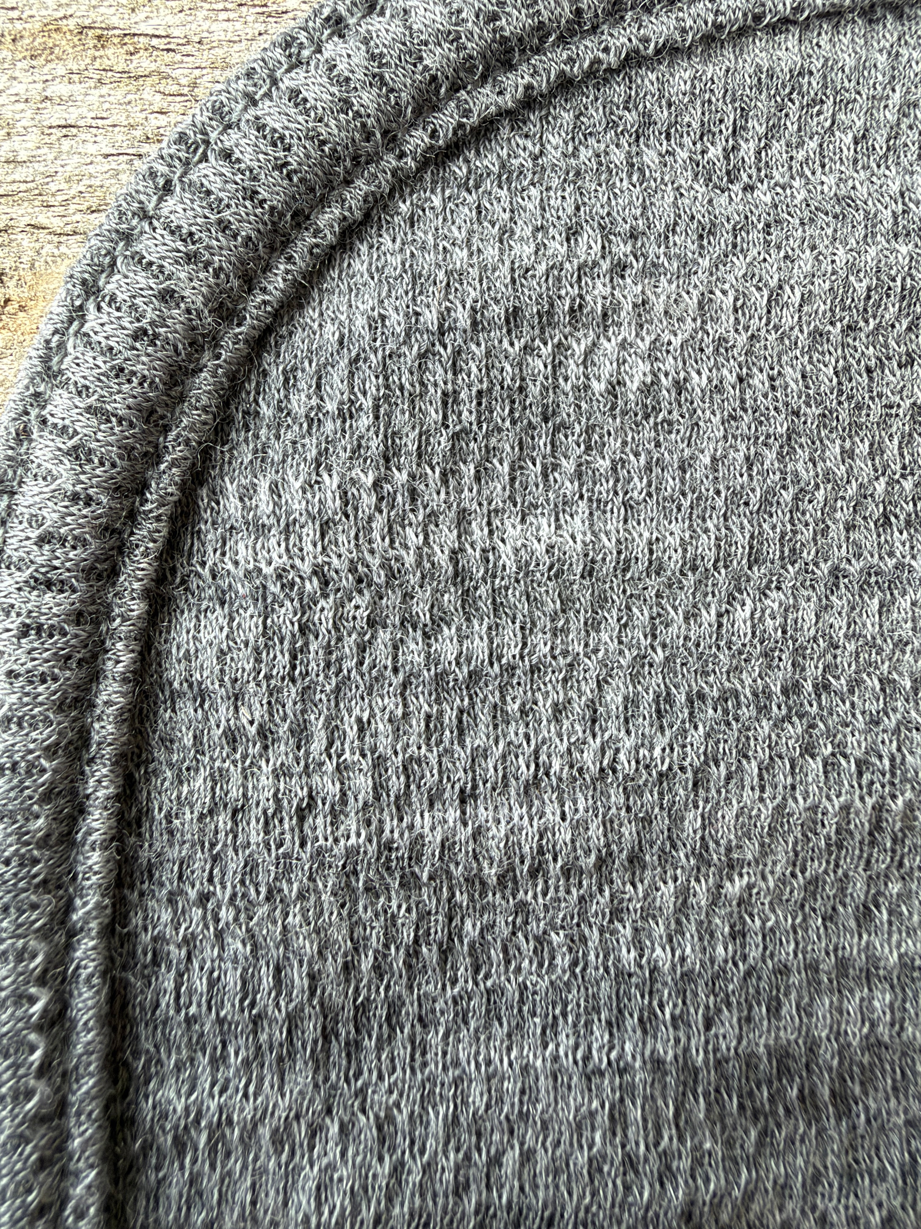 Close-up of the stitched rounded edge and mesh texture of the gray Zpacks collaboration Trail Rag