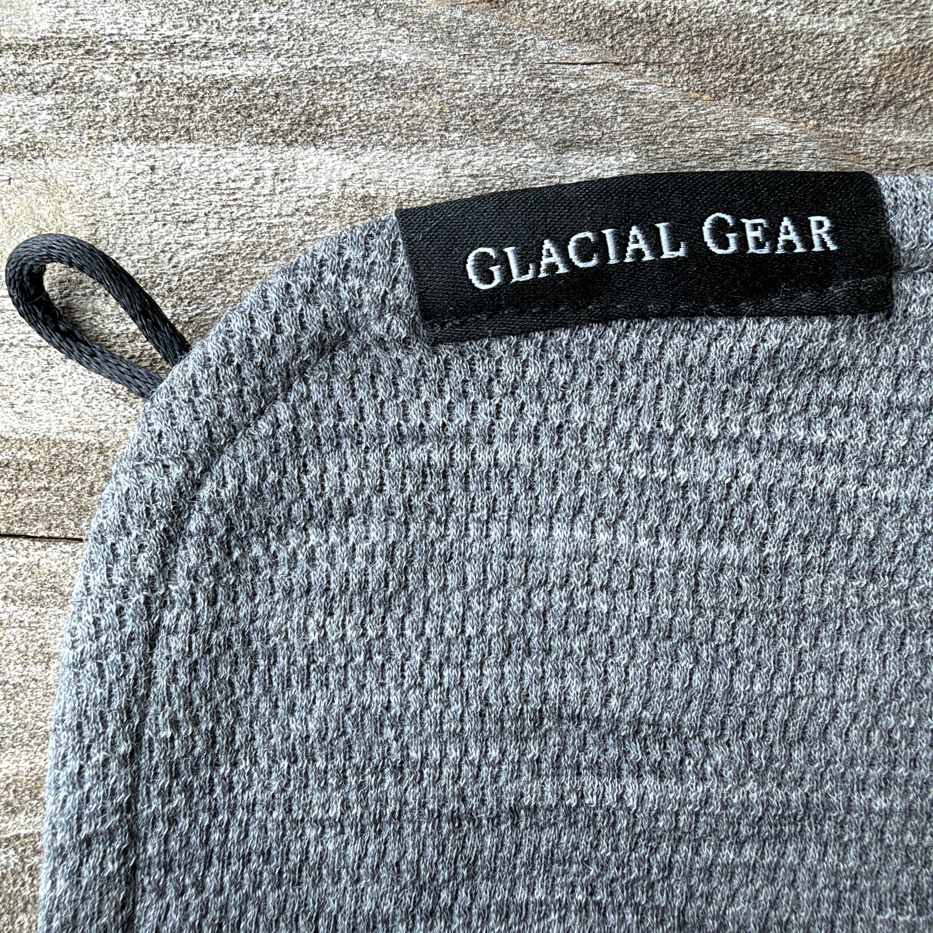 Close-up of the Glacial Gear x Zpacks Trail Rag showing its label, hanging loop, and textured fabric