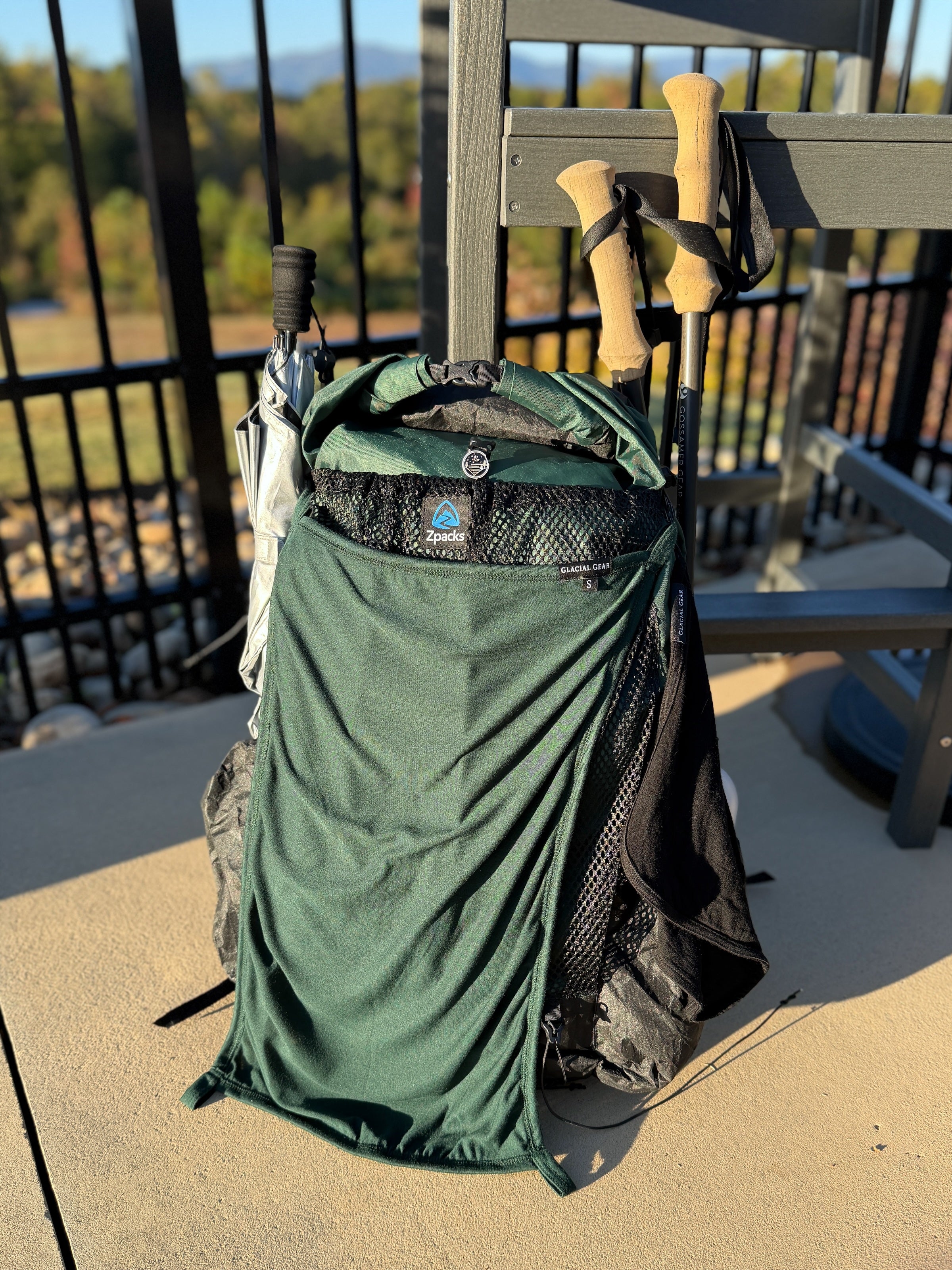 Forest Glacial Gear x Zpacks Camp Towel draped over a Zpacks backpack to dry, with a Black towel hanging from its side