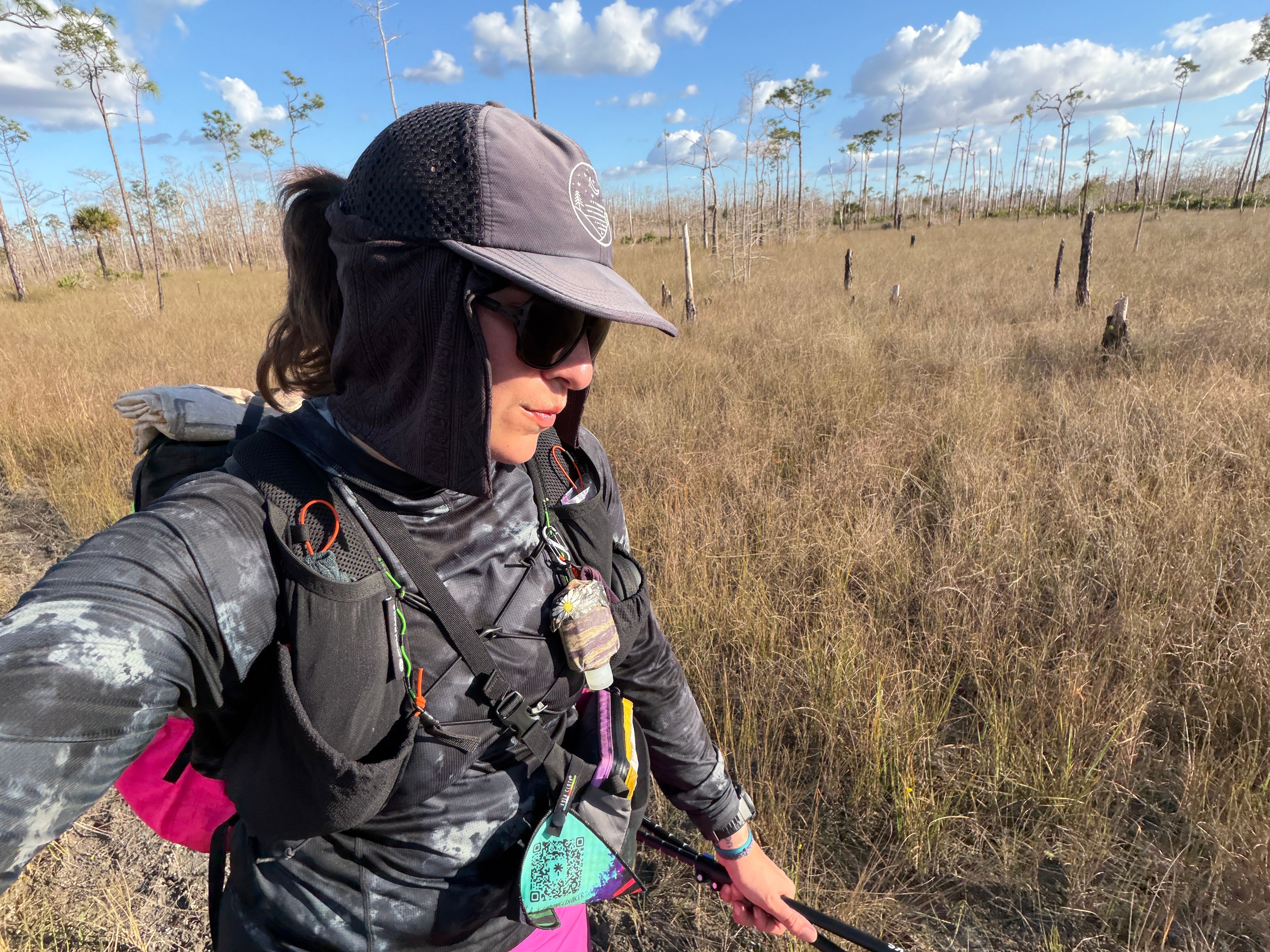 Side view of Jocelyn Smith hiking in her Glacial Gear Foldable Trail Hat, showing the mesh panels and soft crown