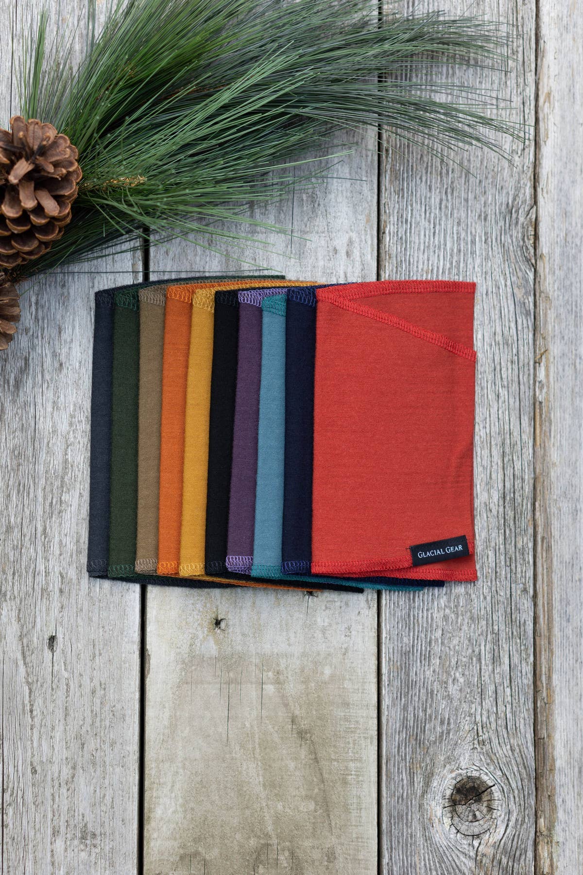 Ultralight Glacial Gaiters in assorted colors arranged on weathered wood