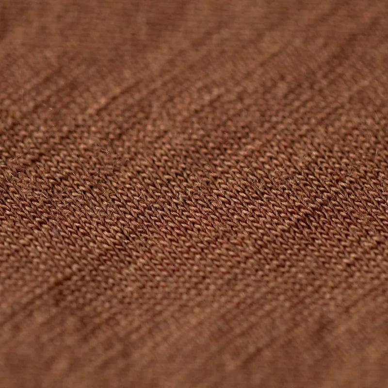 A close-up of the fine knit in our Bark merino wool blanket